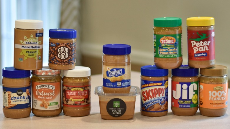 A collection of peanut butter jars on a counter