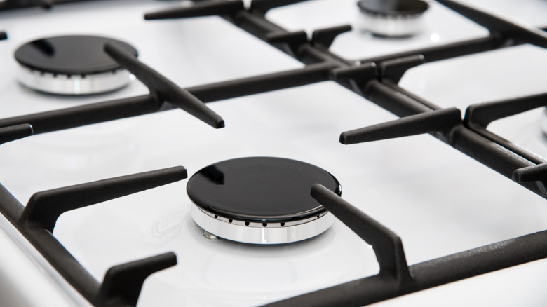 Gas stove top with black burner and black grates