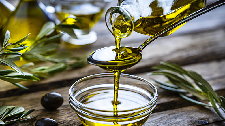 olive oil pouring into bowl