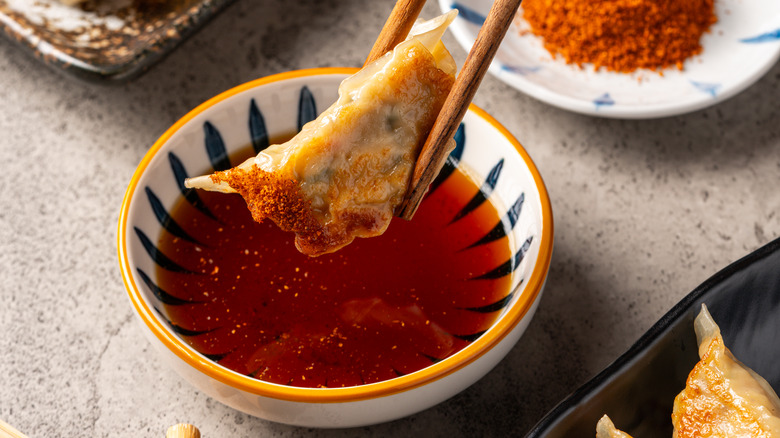 gyoza dipped in spicy sauce