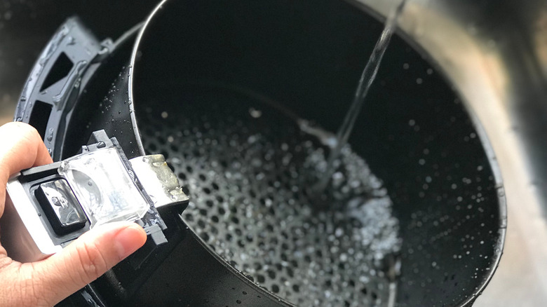 Air fryer being cleaned