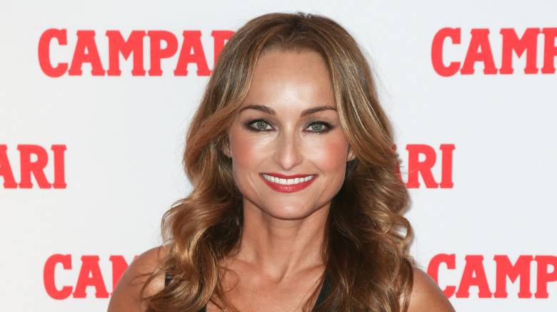 Giada de Laurentiis smiling in front of Campari logos