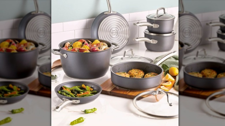 A set of Anolon Accolade pots and pans sitting on a white countertop
