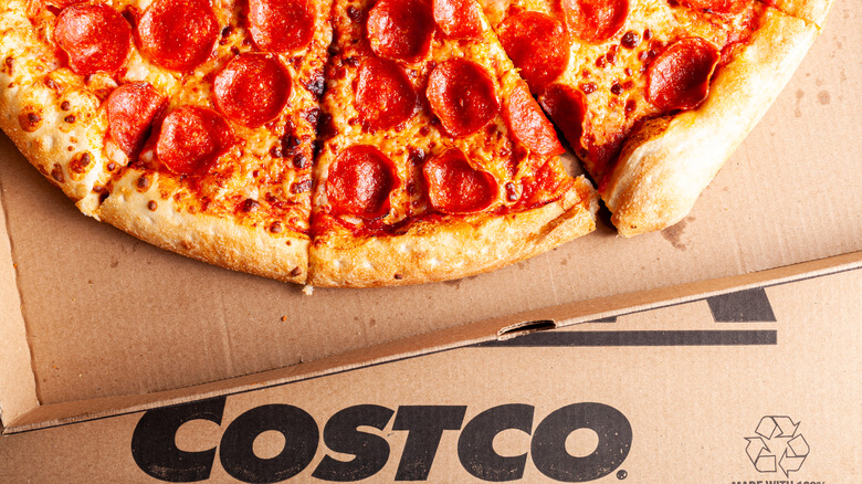 Slices of Costco pepperoni pizza on cardboard.