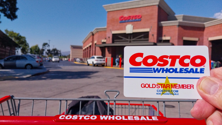 Costco Gold Star membership card in front of Costco storefront