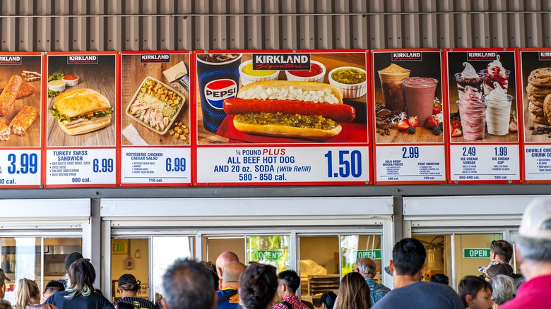 Costco food court menu with a crowd below