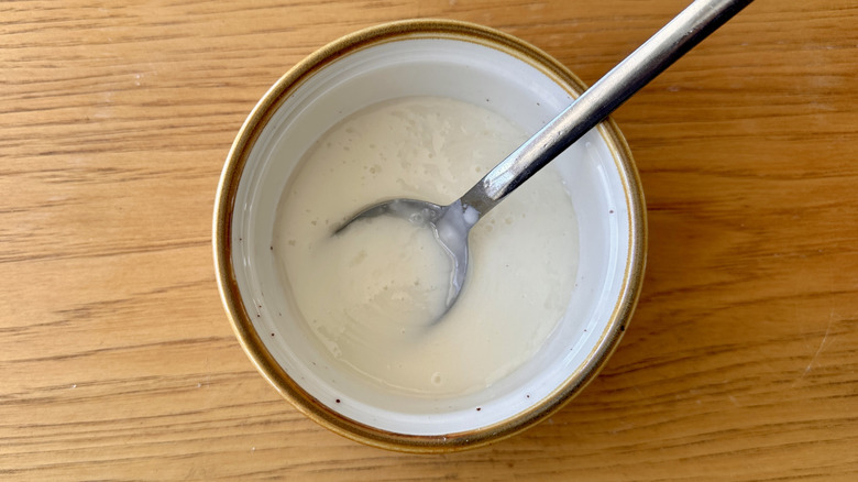 Icing in ramekin with spoon