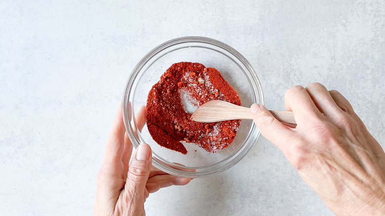 Mixing dry rub ingredients in bowl
