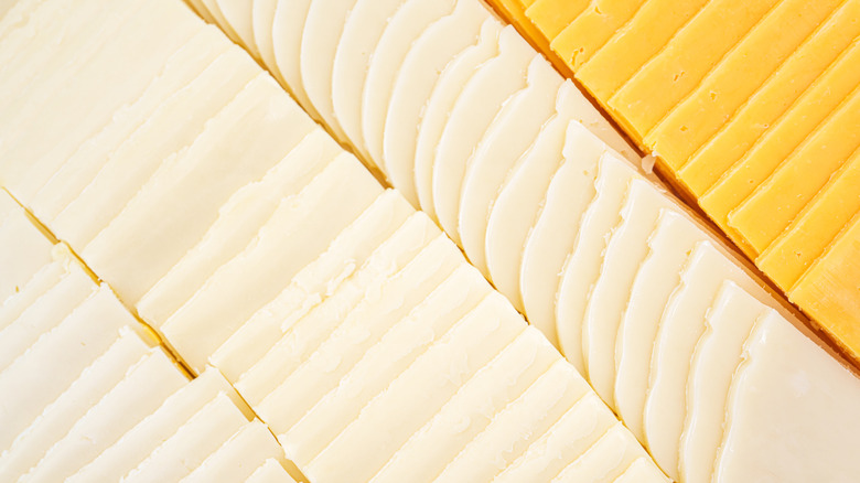 Rows of pre-sliced deli-style cheeses
