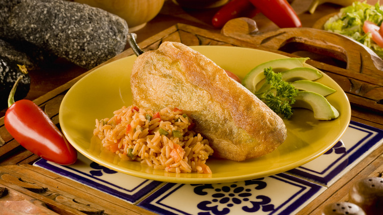 chile rellenos on plate with rice