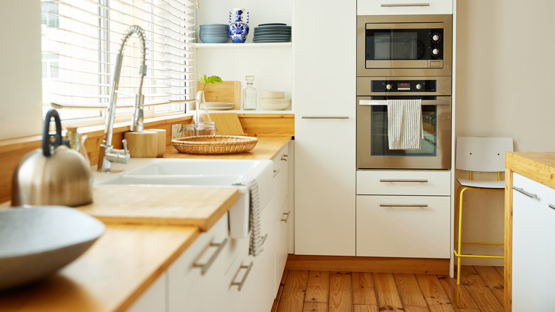 Modern, minimalist kitchen with white and wood features