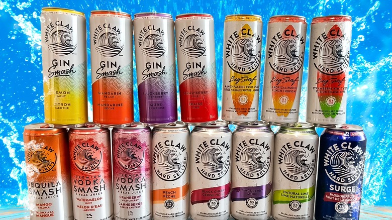 Various White Claw cans on watery background